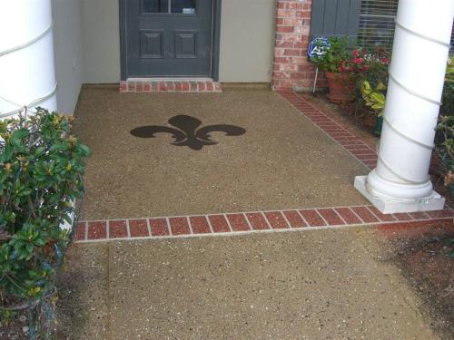 Decorative Concrete front porch with brick borders and a Fleur De Lis
