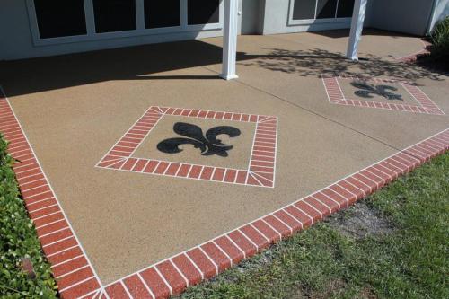 Decorative Concrete patio with brick borders and a Fleur De Lis