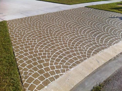Driveway resurfacing with european fan cobblestone apron and brick borders