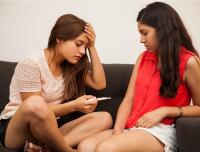 pregnant teen with her teenage friend