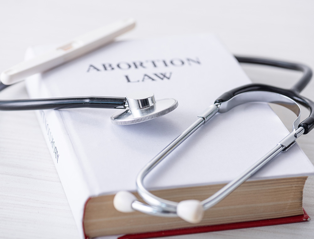 book that says abortion law and a stethoscope