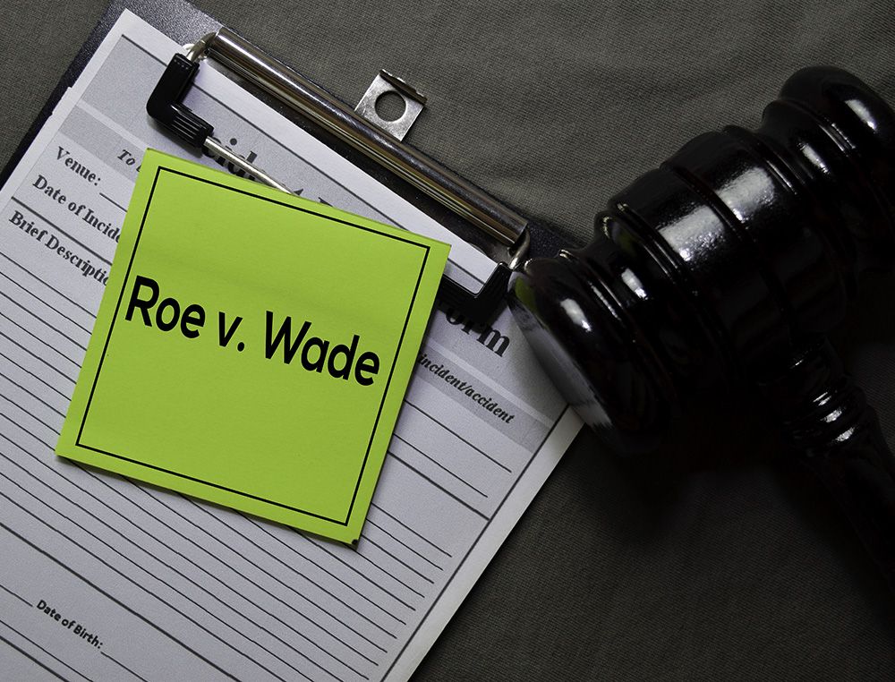 Department of Health document and note that reads Roe v. Wade with gavel