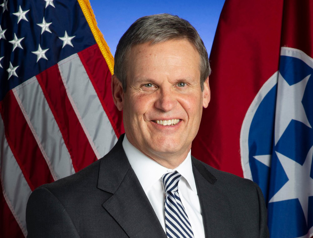 Gov. Bill Lee official photo against backdrop of U.S. and Tennessee flags