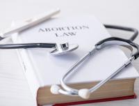 abortion law book and stethoscope