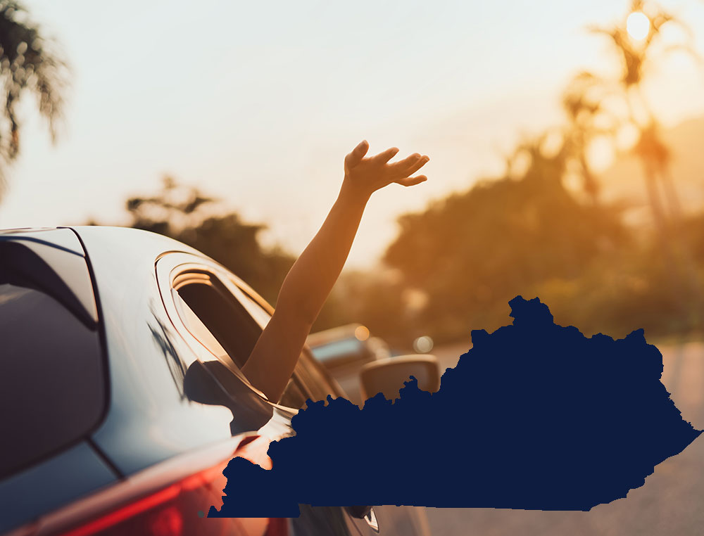 hand raised out of car window and state outline for Kentucky