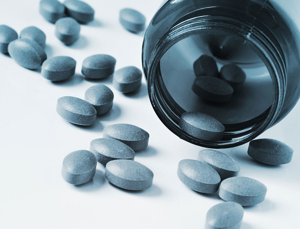 pills spilling out of a medicine bottle