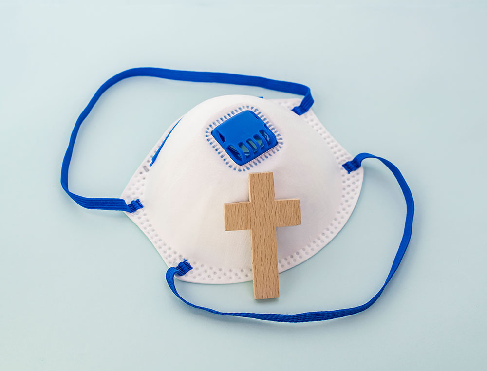 medical  mask and wooden cross