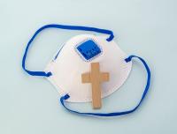 medical  mask and wooden cross