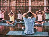 young students practicing yoga