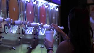 Girl pouring daiquiri from machine
