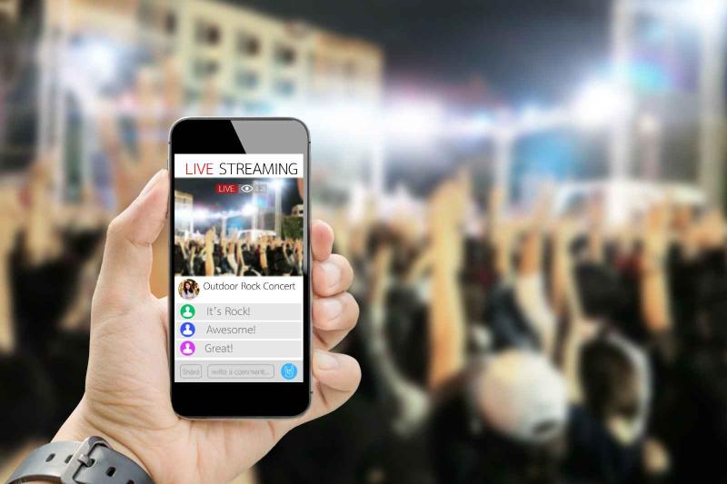 photo of phone with streaming app at concert