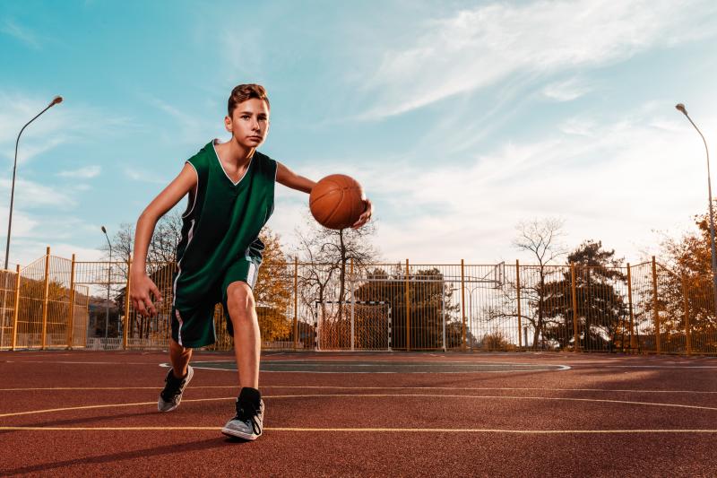 Boy playing basketball outside