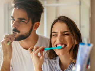 Couple brushing teeth