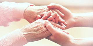 cancer caregiver holding hands