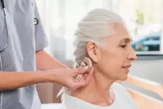lady getting a hearing aid