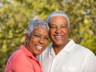 couple smiling at camera | Dental implants in Baton Rouge 70809