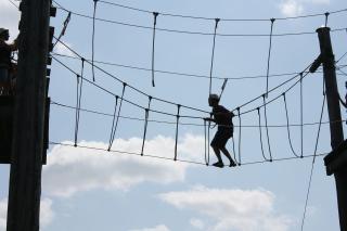 Person navigating a ropes course