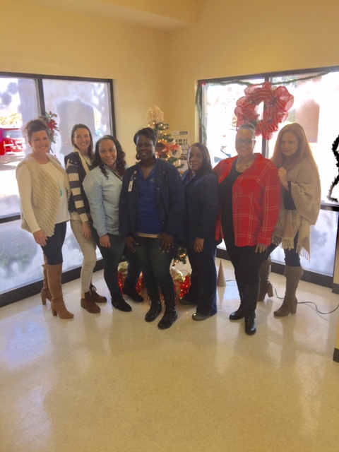 Employees socializing by the tree