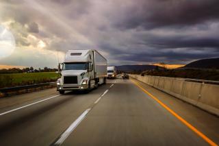 Freeway scene with a mix of trucks and cars traveling on the road