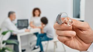 A Premier Hearing Aid Displayed in Doctor's Hand for Repair in Florida