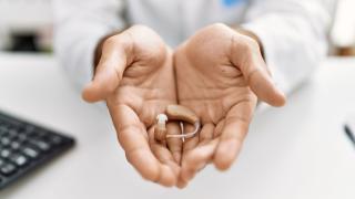 A Hearing Aid Machine in Audiologist's Hand for Maintenance in Florida