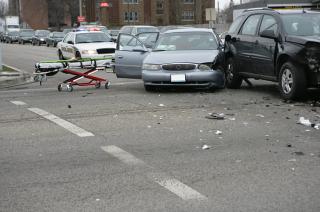 Gray car crashed into rear corner of black car