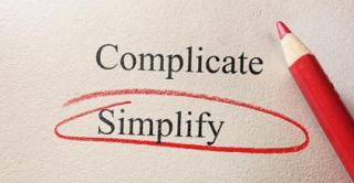 red pencil with the words Complicate and Simplify and simplify is circled in red