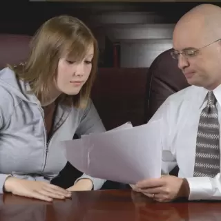 Attorney reviewing paperwork with a client