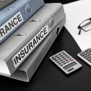Insurance binders on a desk