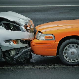 Orange car crashed into a gray car