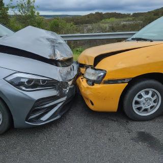 silver car crashed into a yellow car