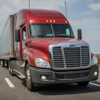 Red semi-truck on a highway