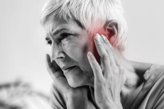 A woman suffering from ringing in her ears due to her new medication