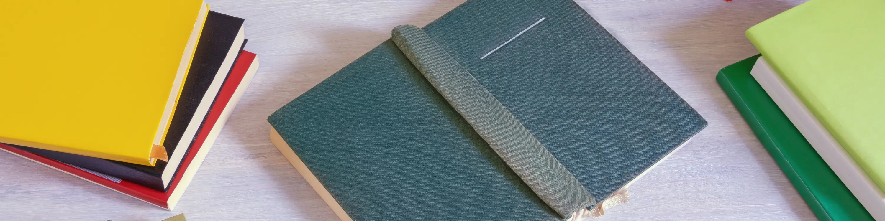 Various handbooks, guides, and books atop a desk.