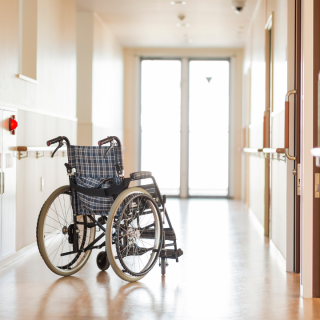 A plaid wheelchair in a white hallway in Longview Texas - Nursing Home Neglect Attorneys