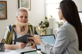 a woman with a neck injury getting a free consultation with an injury lawyer from sloan firm