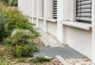French drain cross section showing pipe and gravel used in drainage planning for wet yards