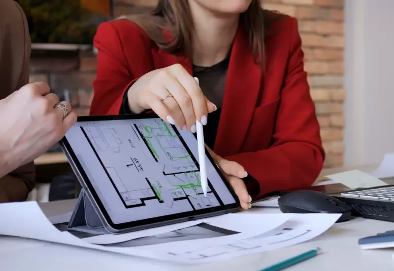 Homeowners discussing floor plans and new construction mortgage options with a builder.