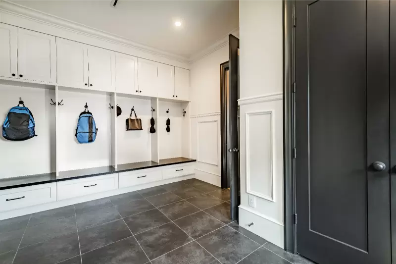 Mudroom laundry room combo with bench, hooks, and durable tile flooring for Gulf Coast sand and rain