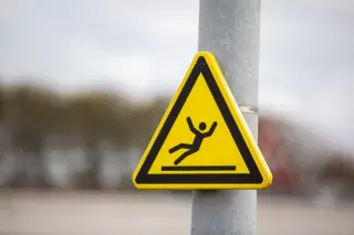 Yellow slippery floor warning sign premises liability