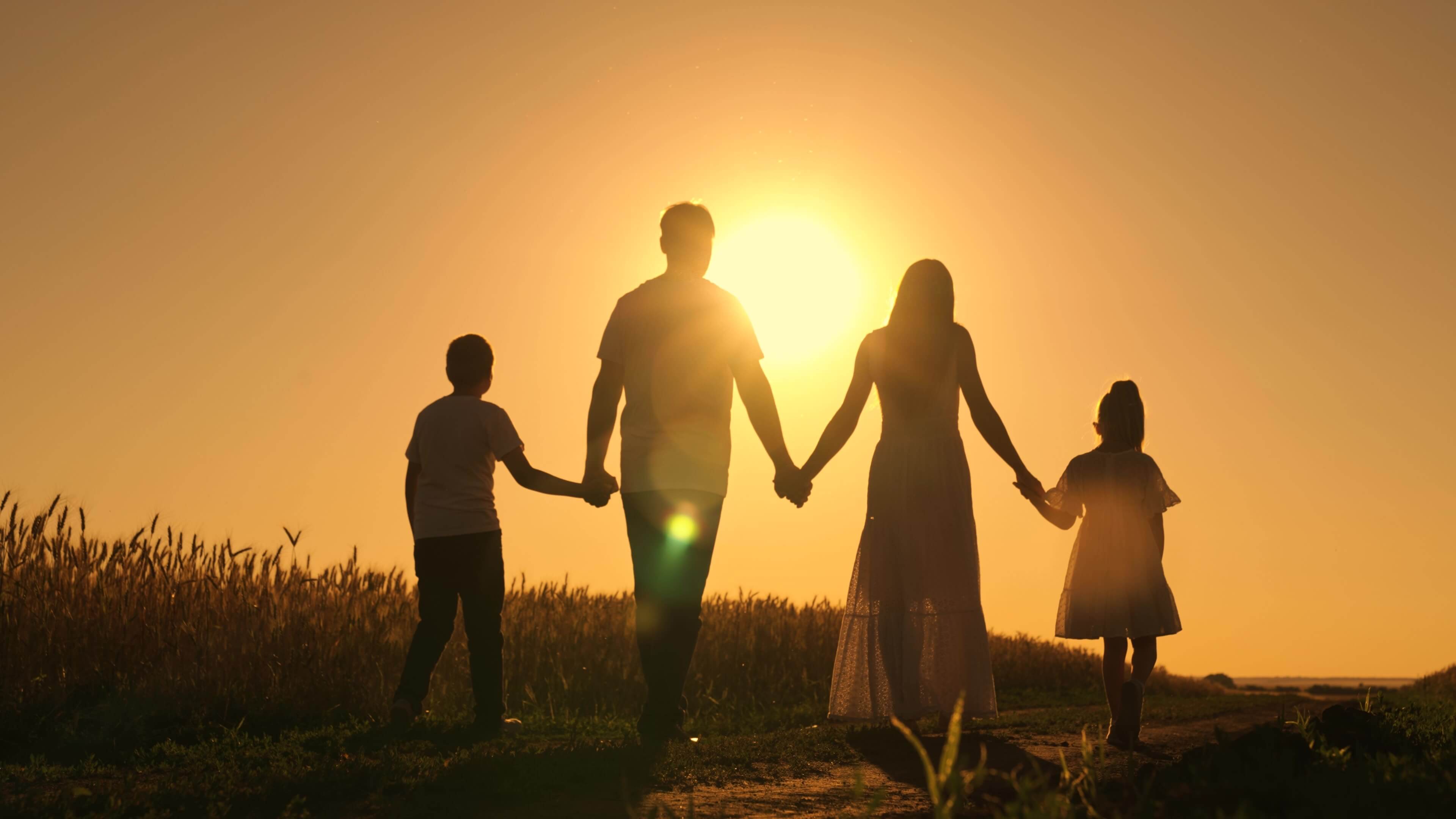 traditional family walking during a sunset