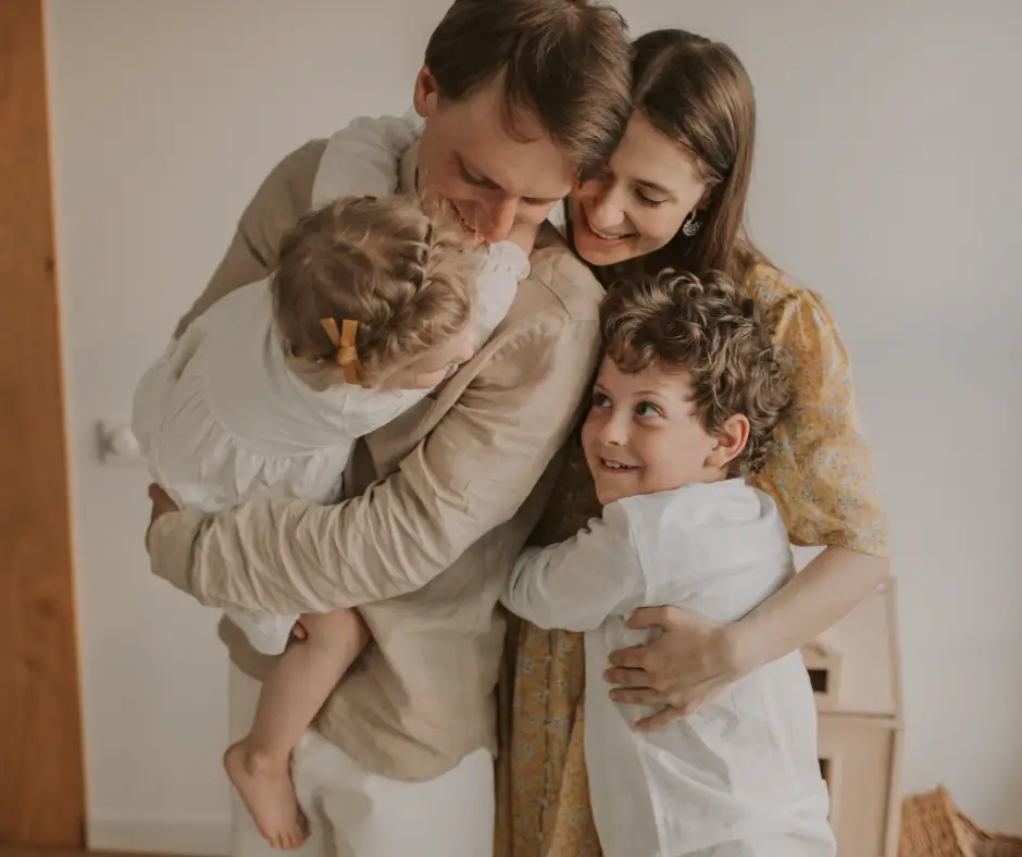 family of four embracing