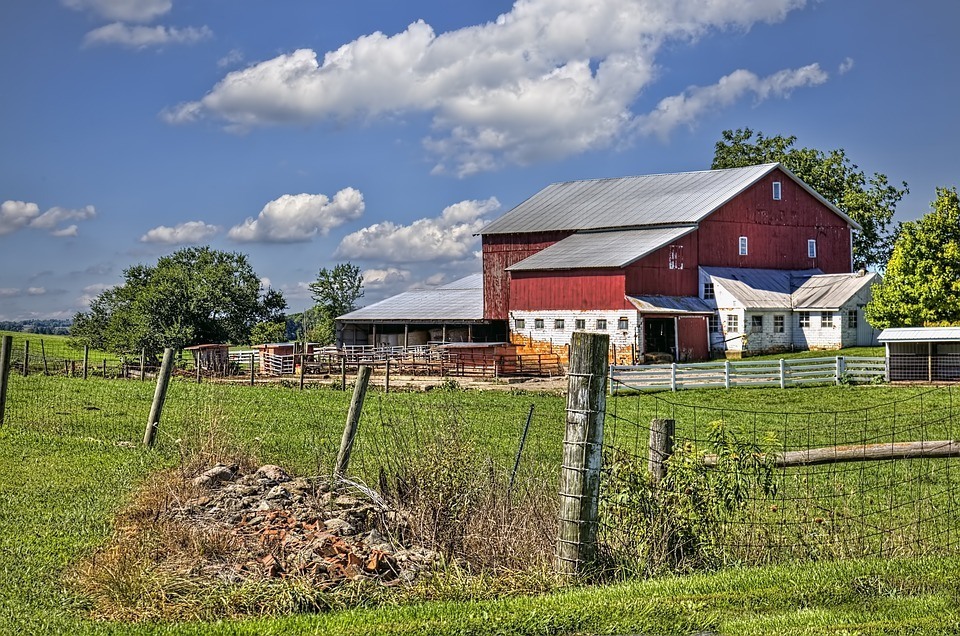 Predator Guard red farm surrounded by wire fencing