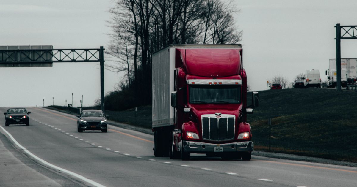 Semi Truck driving down highway, Considerations When Hiring a Commercial Trucking Accident Attorney