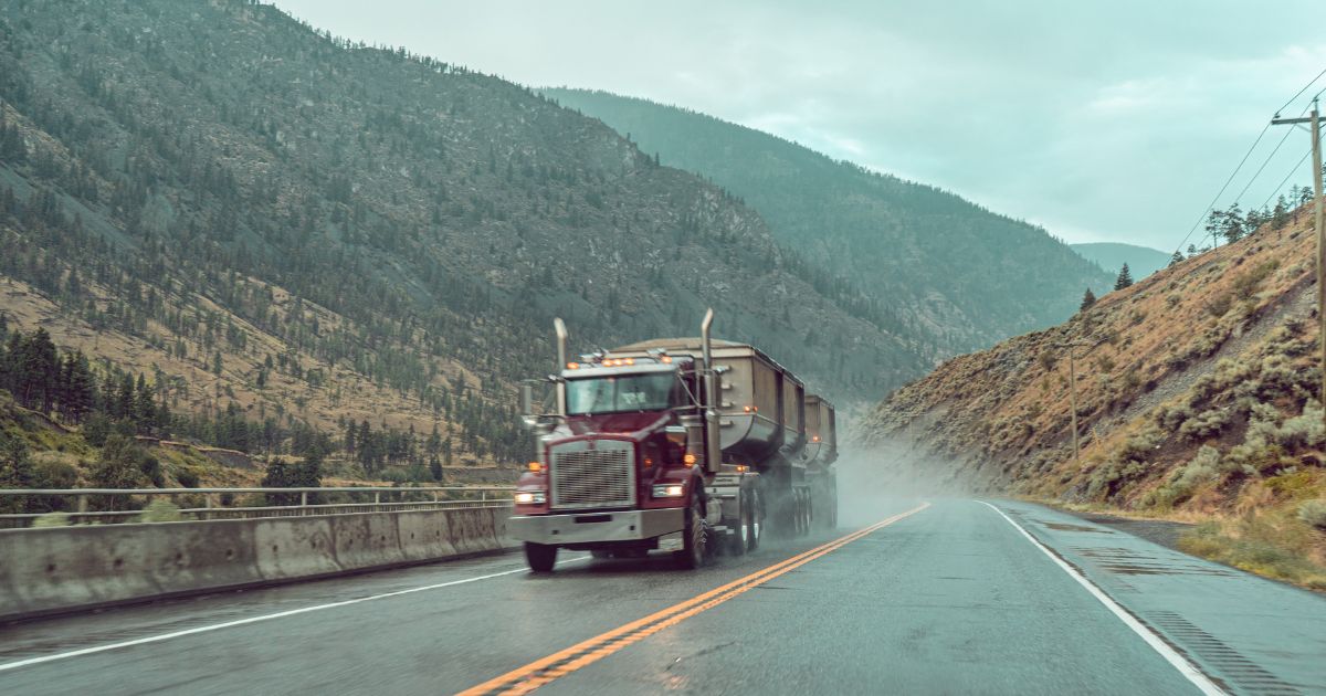 Semi Truck driving on wet road, Considerations When Hiring a Commercial Trucking Accident Attorney