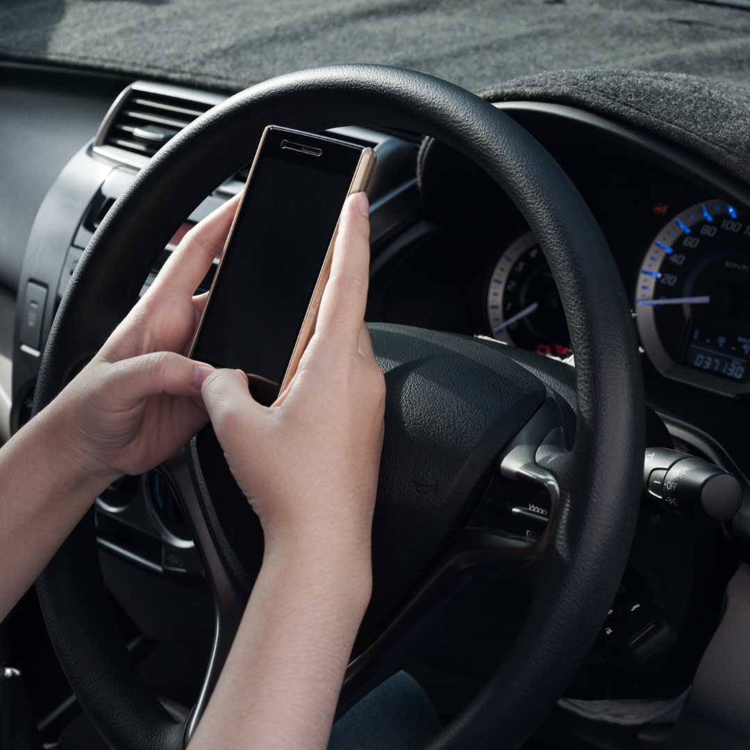 Woman Driving With Phone In Hands