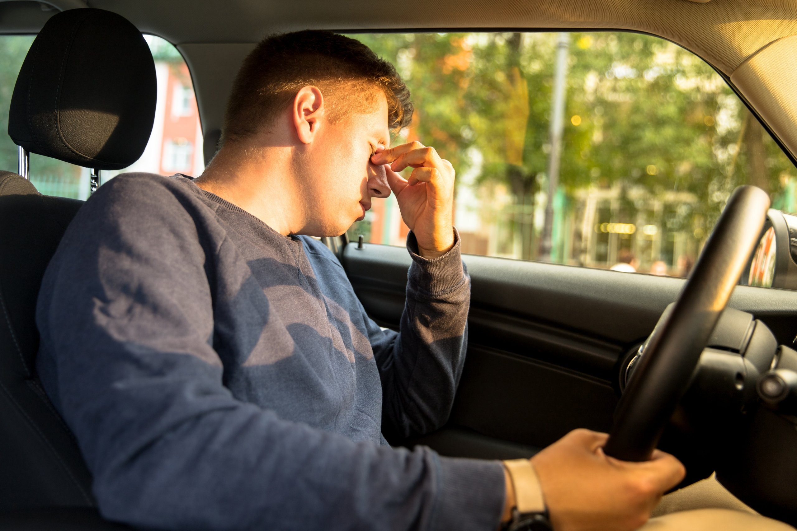 Tired man driving a car