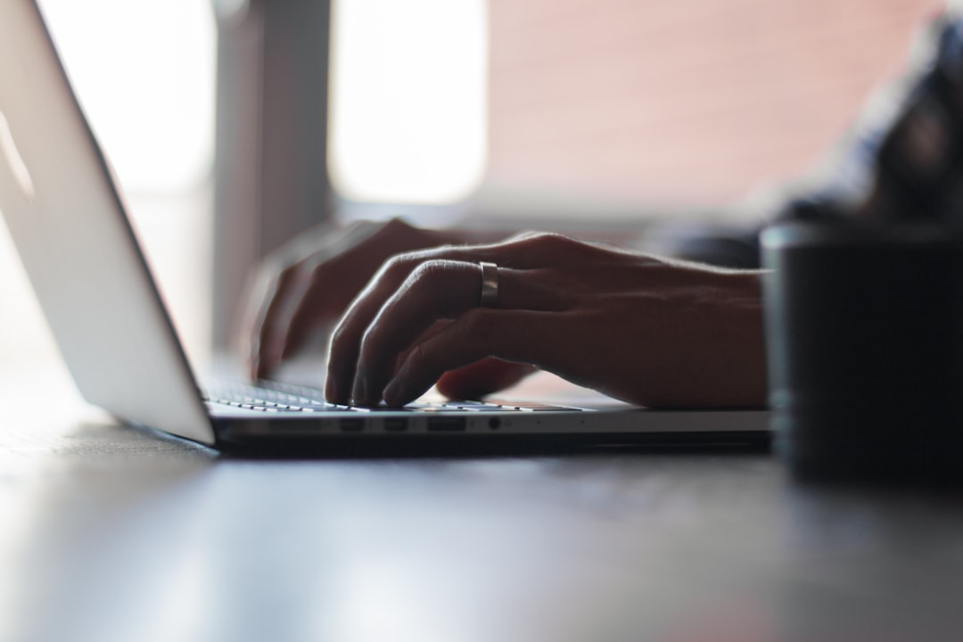 hands typing on a laptop computer keyboard