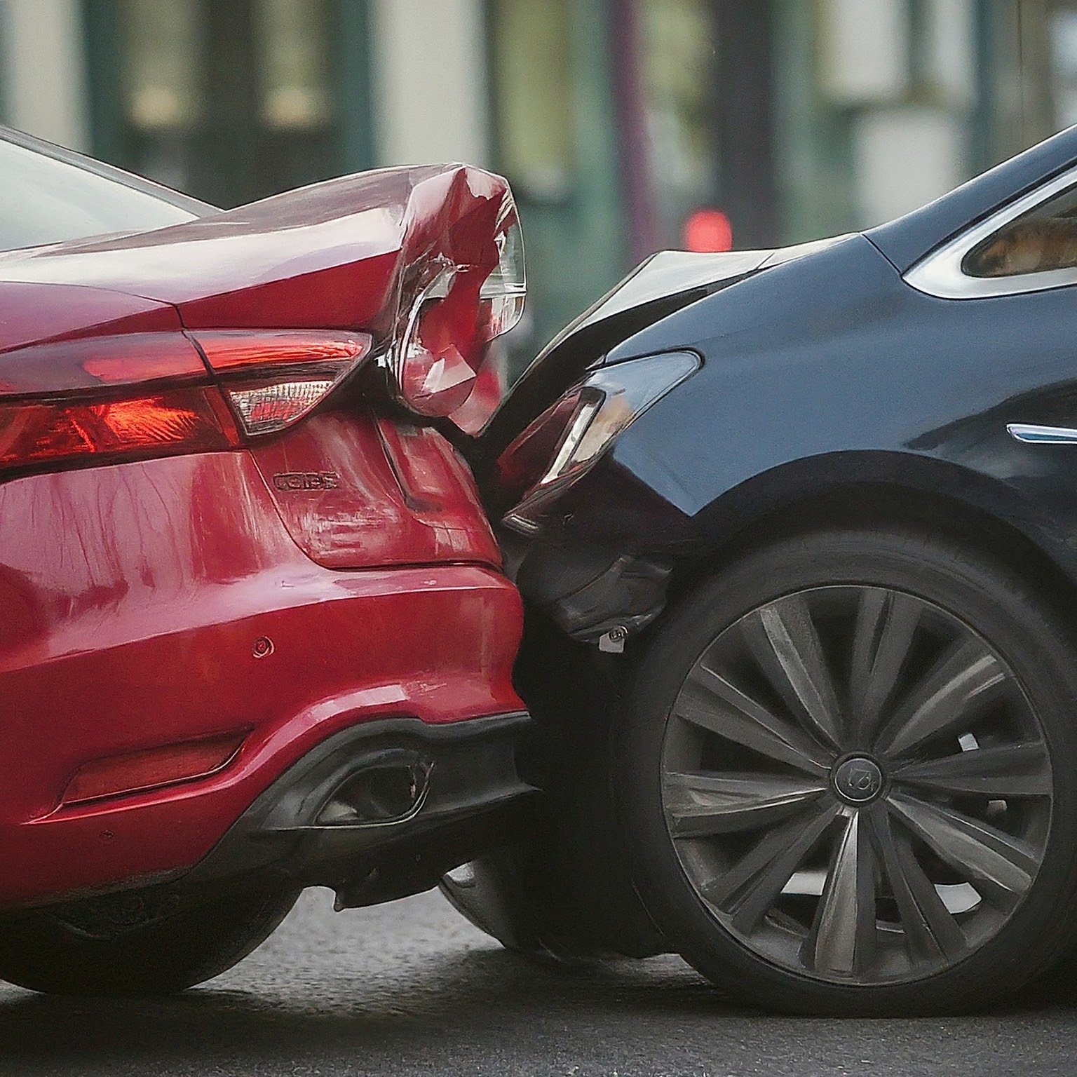 Black car rear ending a red car