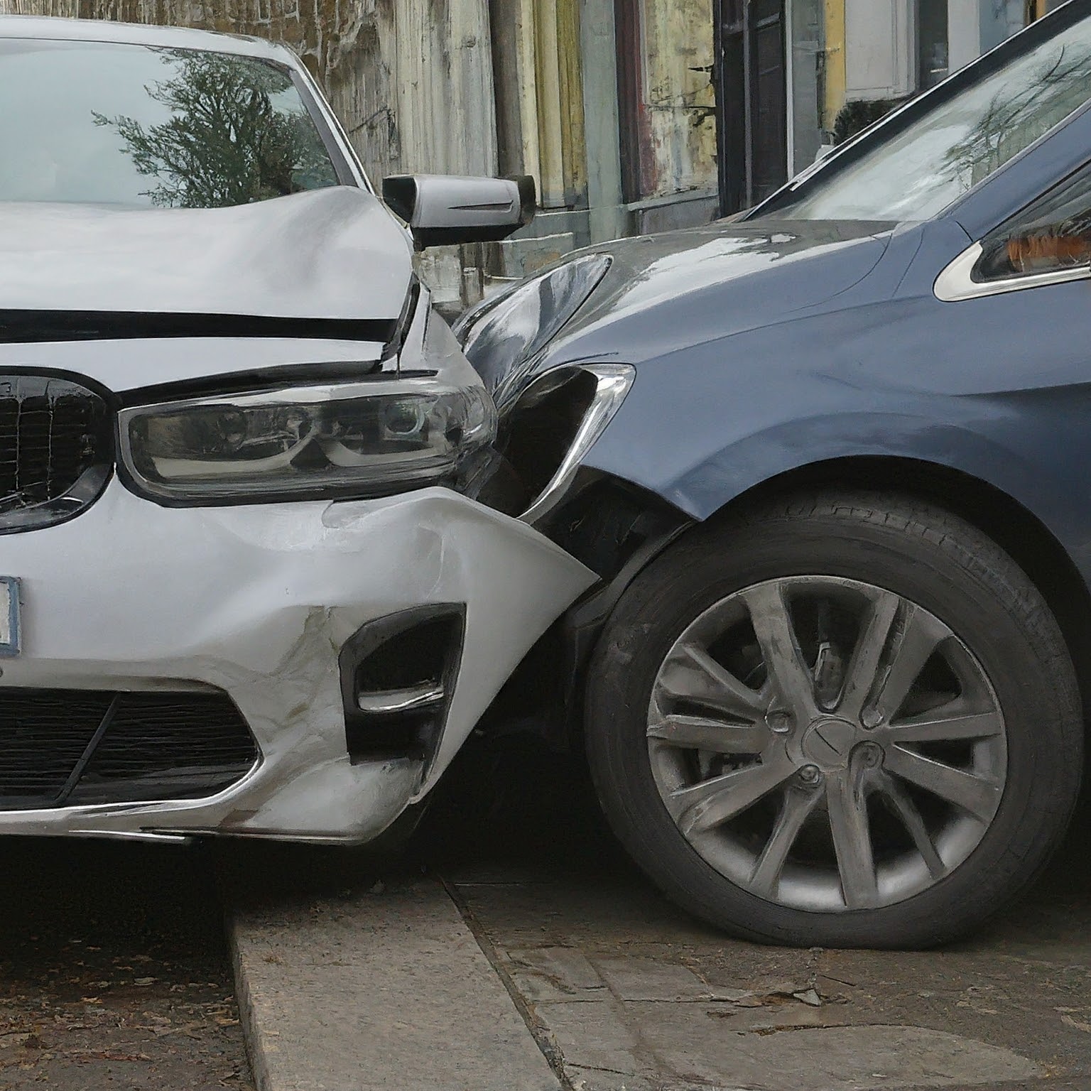 Blue car crashed into the side of white car